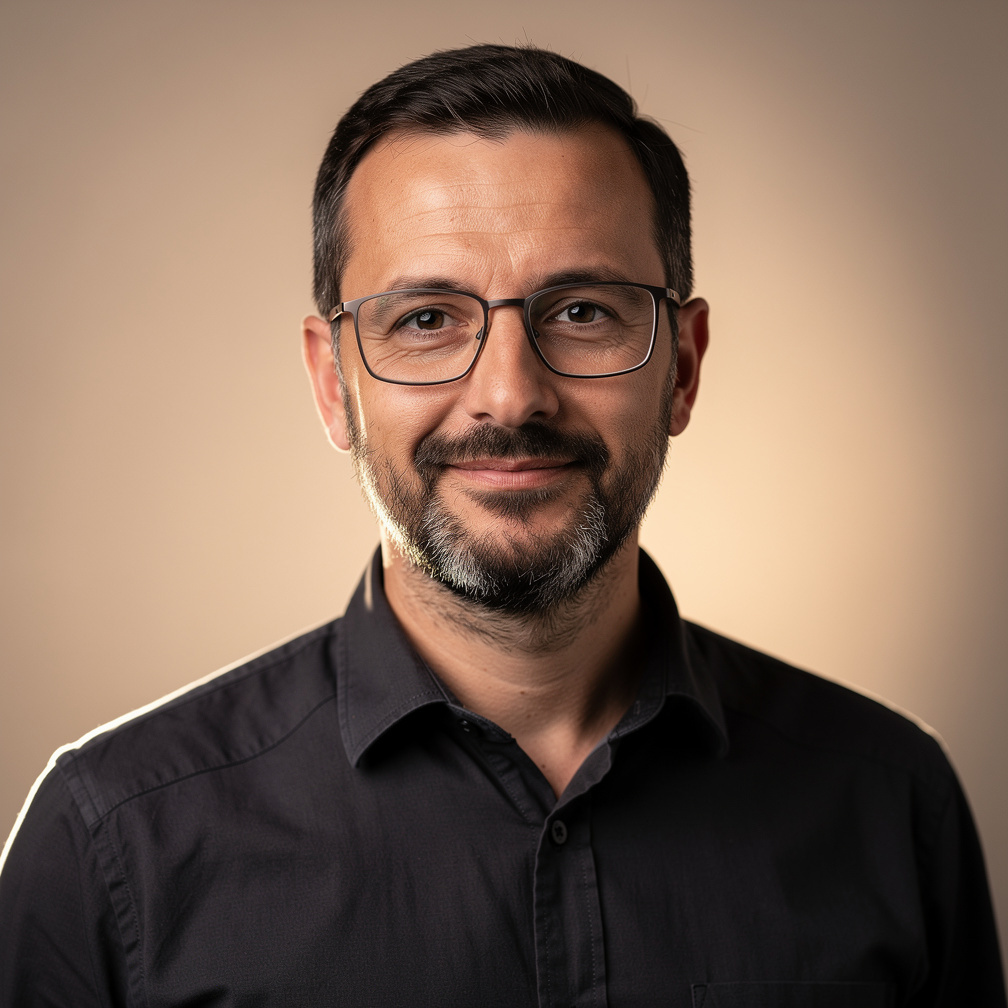 Portrait of a European man in his forties wearing glasses, head of lighting design at a media studio